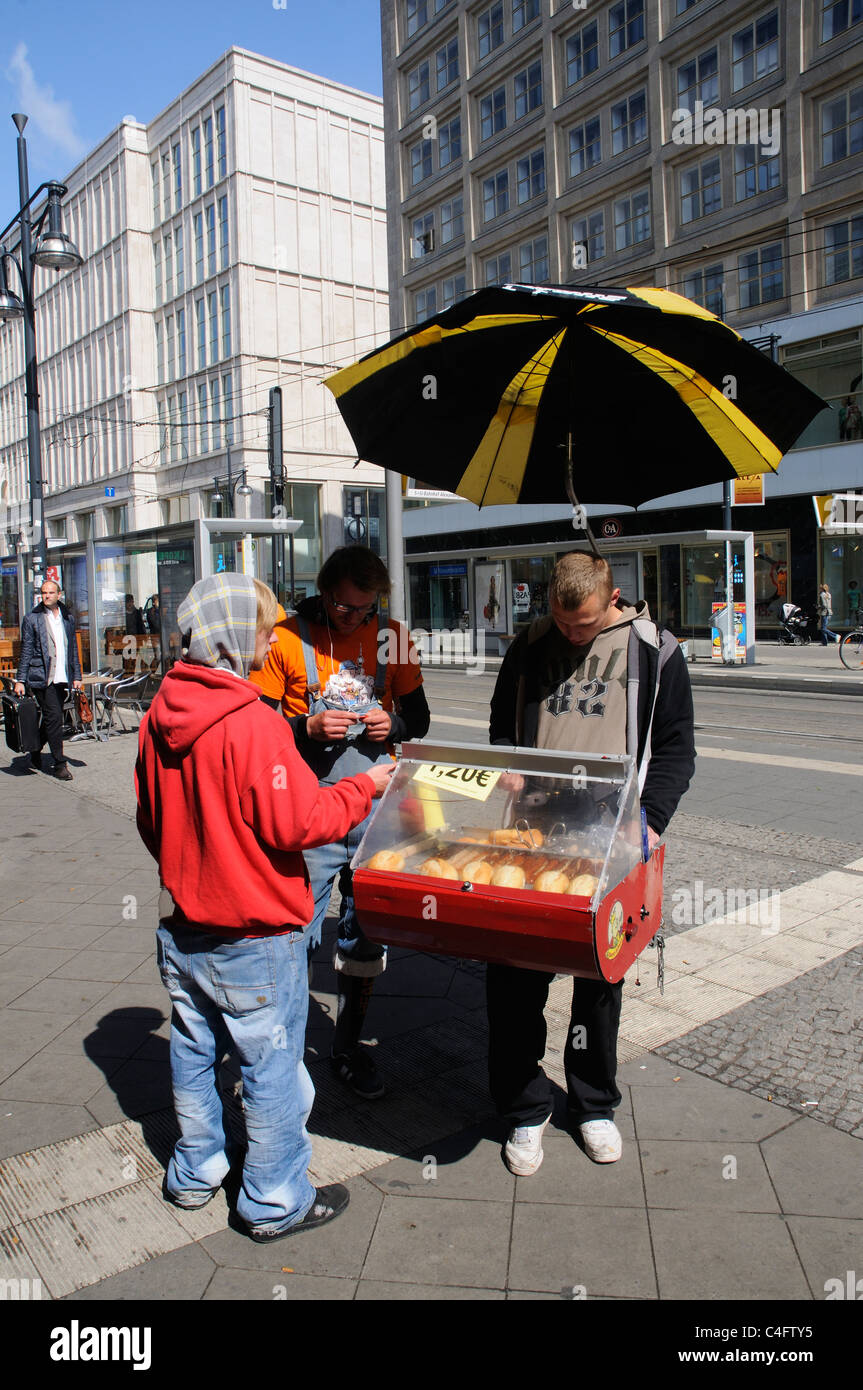 A man buying a bratwurst from a street seller in Berlin Stock Photo