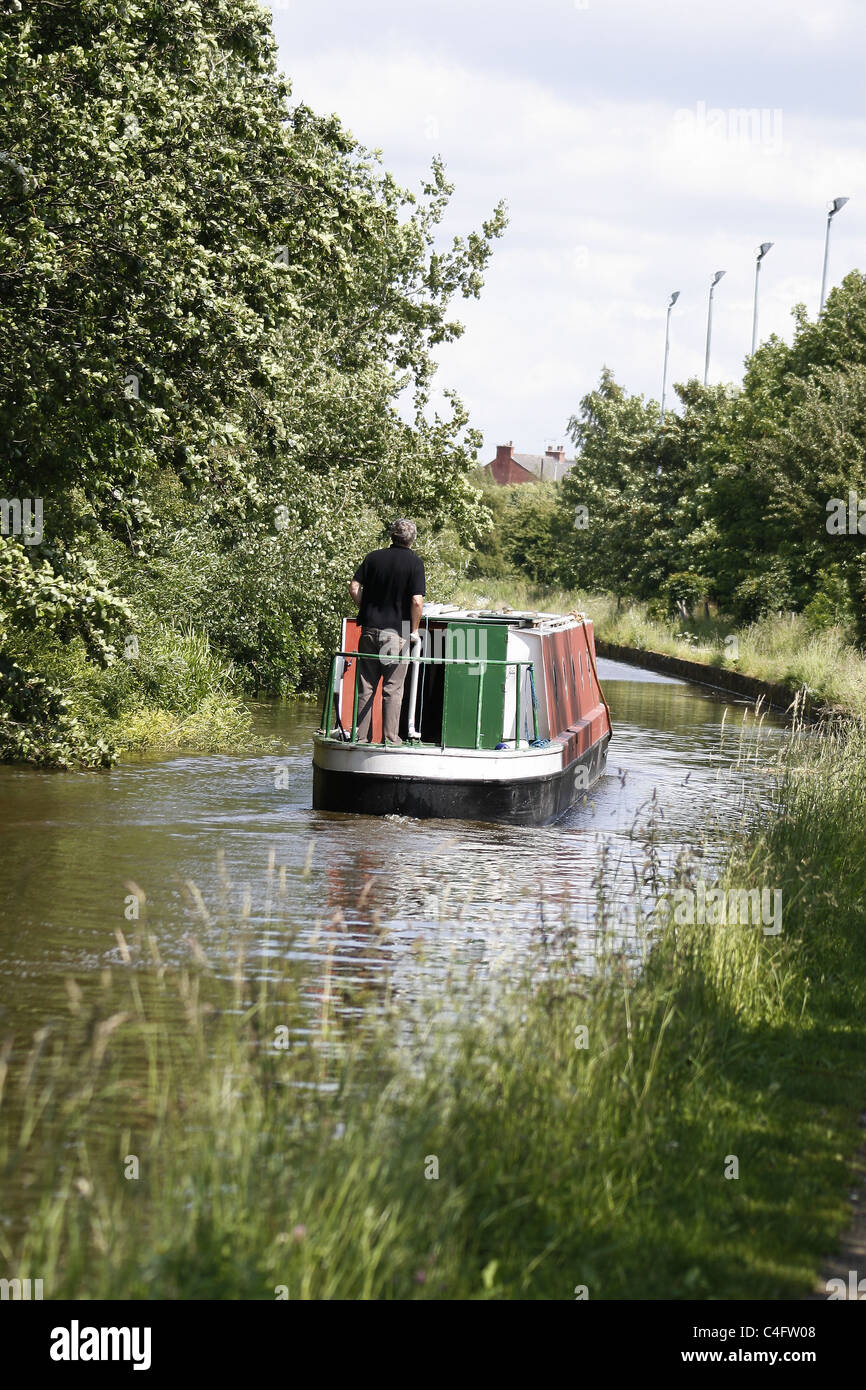 man driving barge on chesterfield canal. Worksop, Notts, England Stock