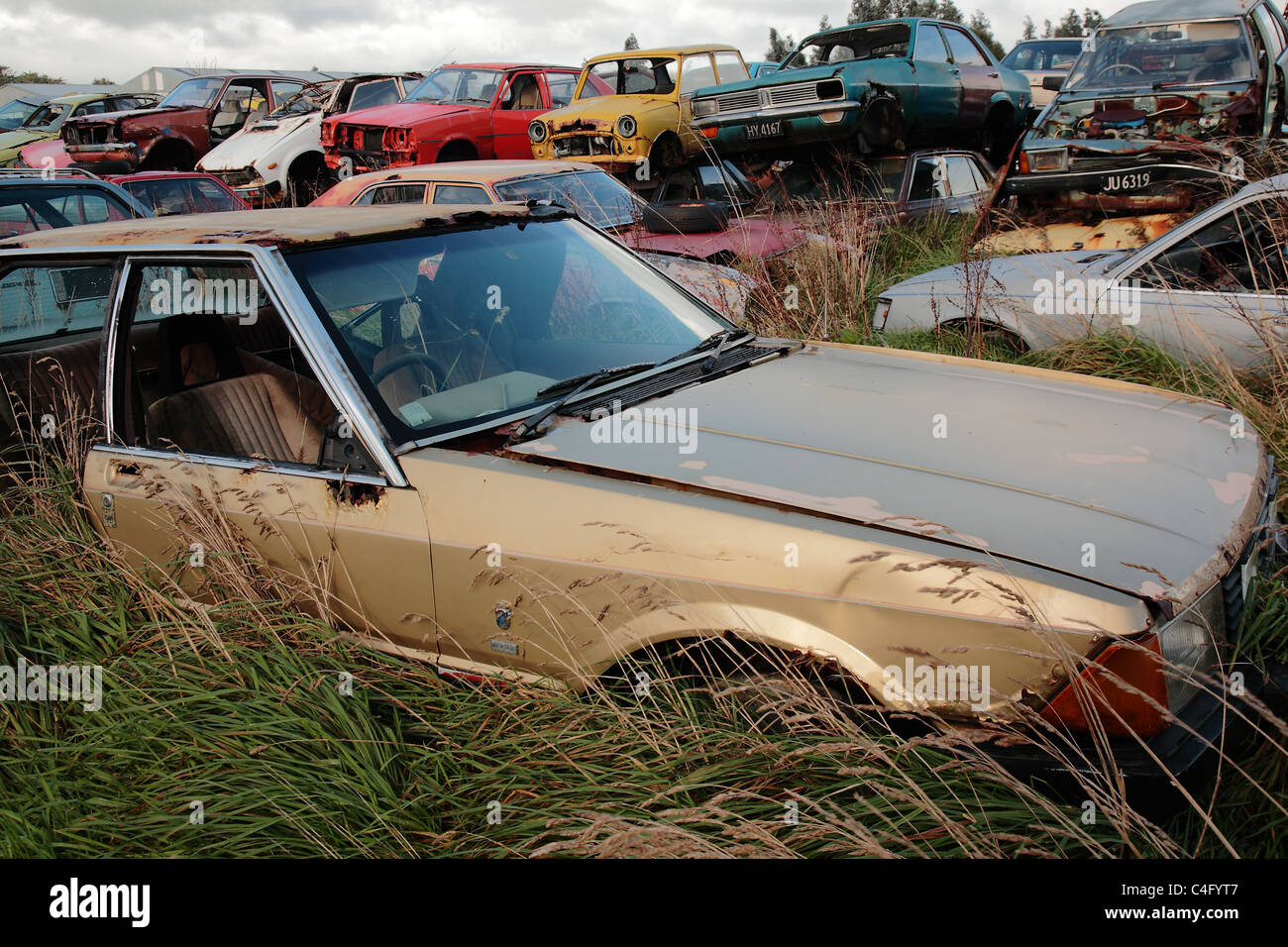 A rusty old car at a scrap yard in Invercargill, New Zealand Stock Photo