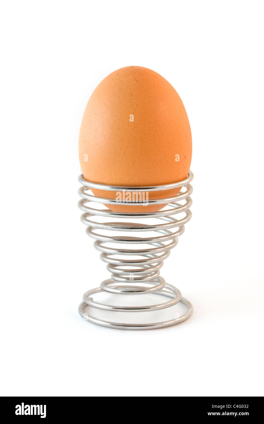 Boiled egg in a metal egg cup isolated over white Stock Photo