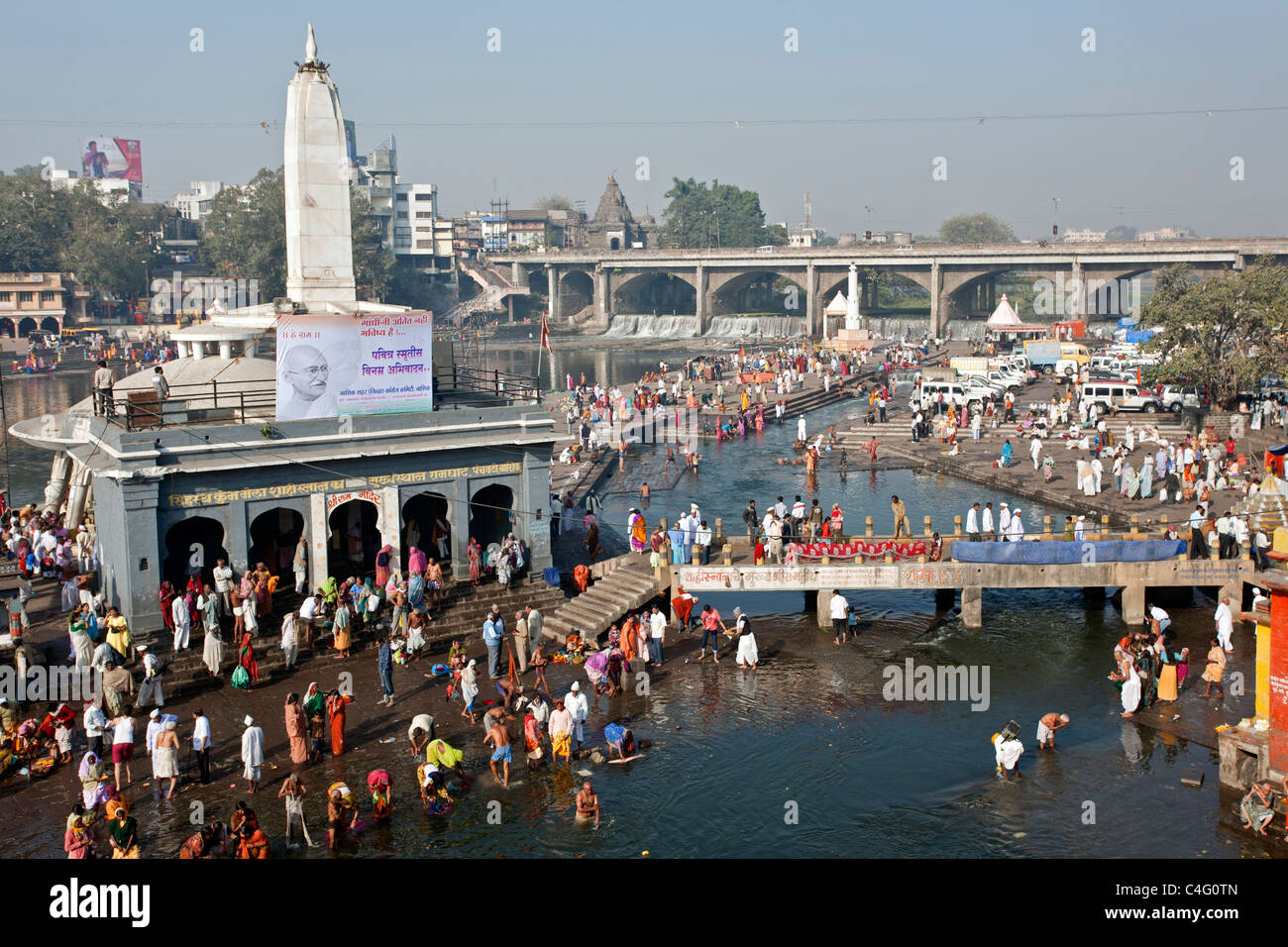 People bathing in the sacred waters of the Godavari river. Ram Kund. Nasik. Maharastra. India Stock Photo