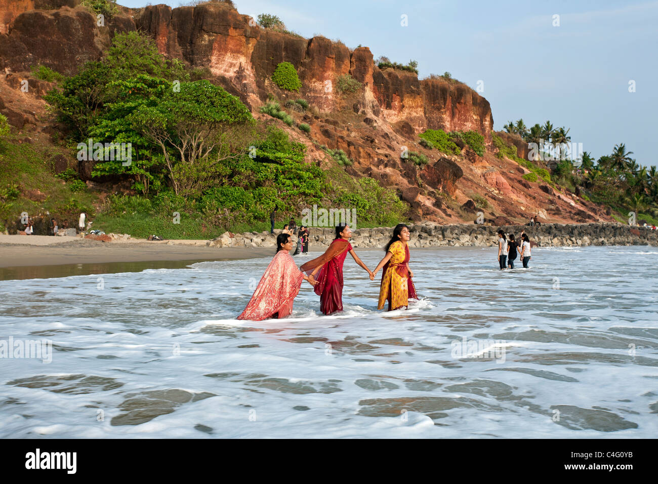 Indian women bathing in the Arabian sea. Varkala beach. Kerala. India Stock Photo