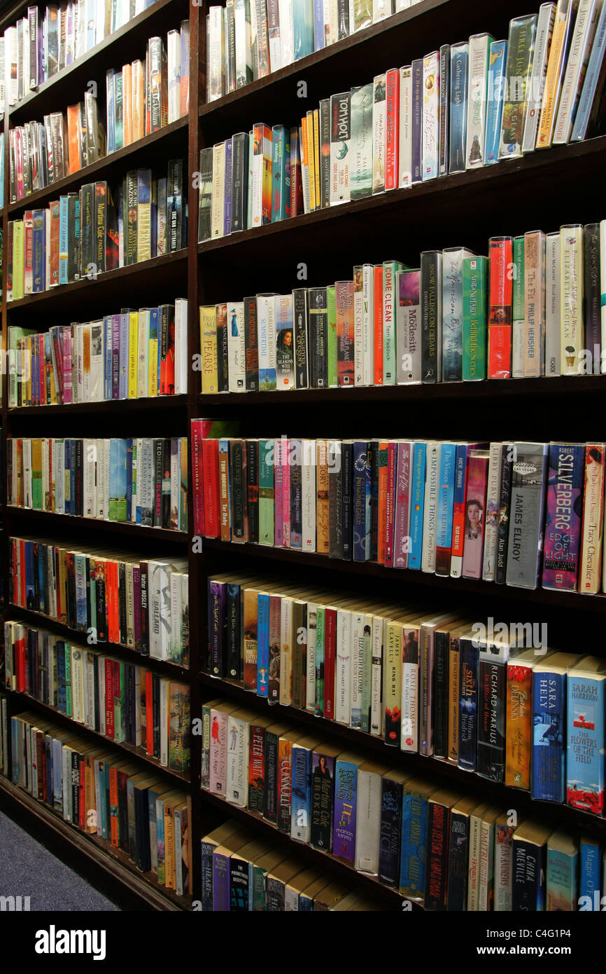 Books on shelves in a library Stock Photo - Alamy
