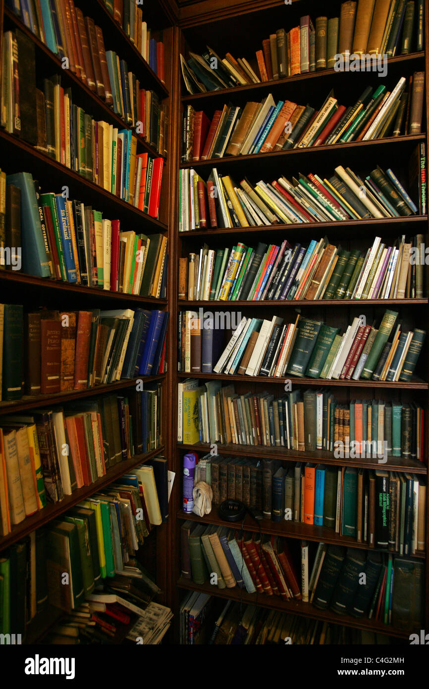 Books on shelves in a library Stock Photo Alamy