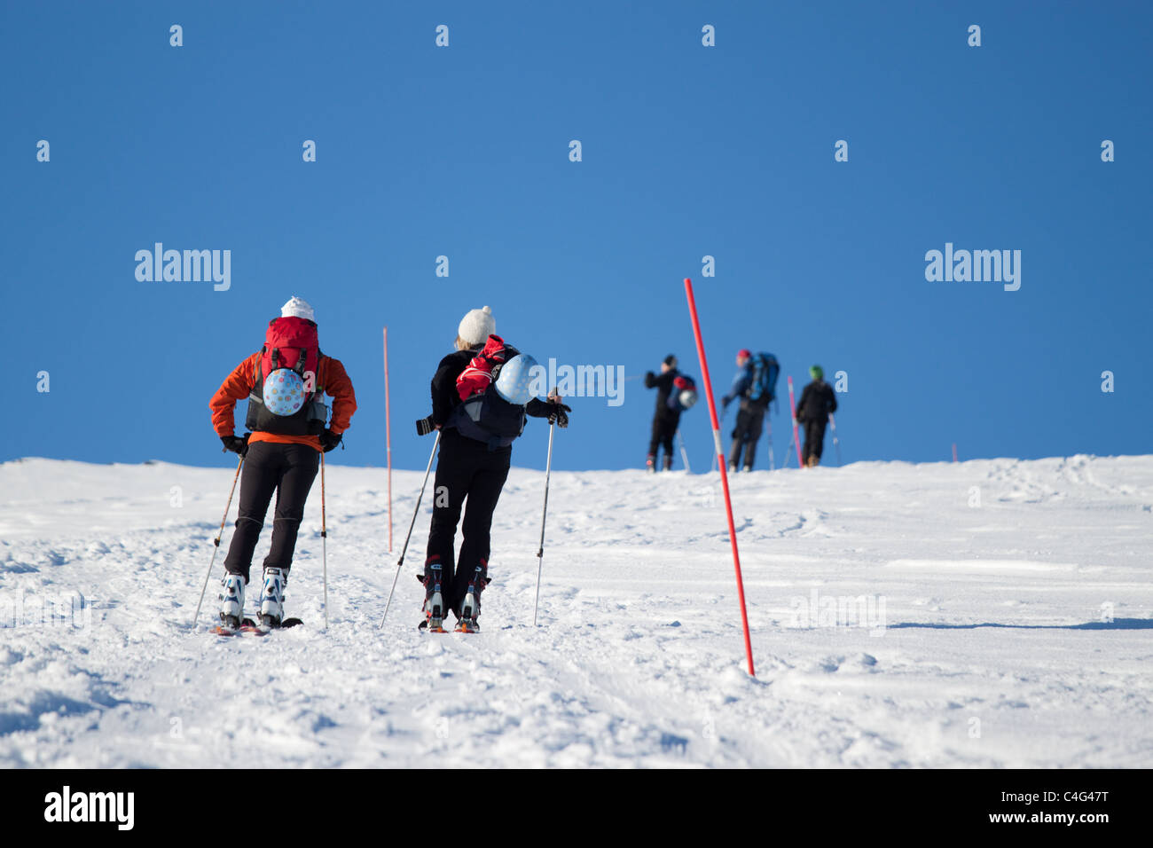 Female skiers with male skiers in the background. Stock Photo