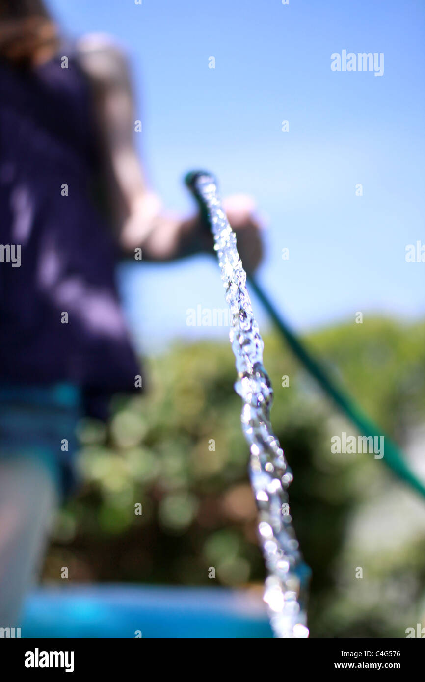 girl with a hose pipe Stock Photo