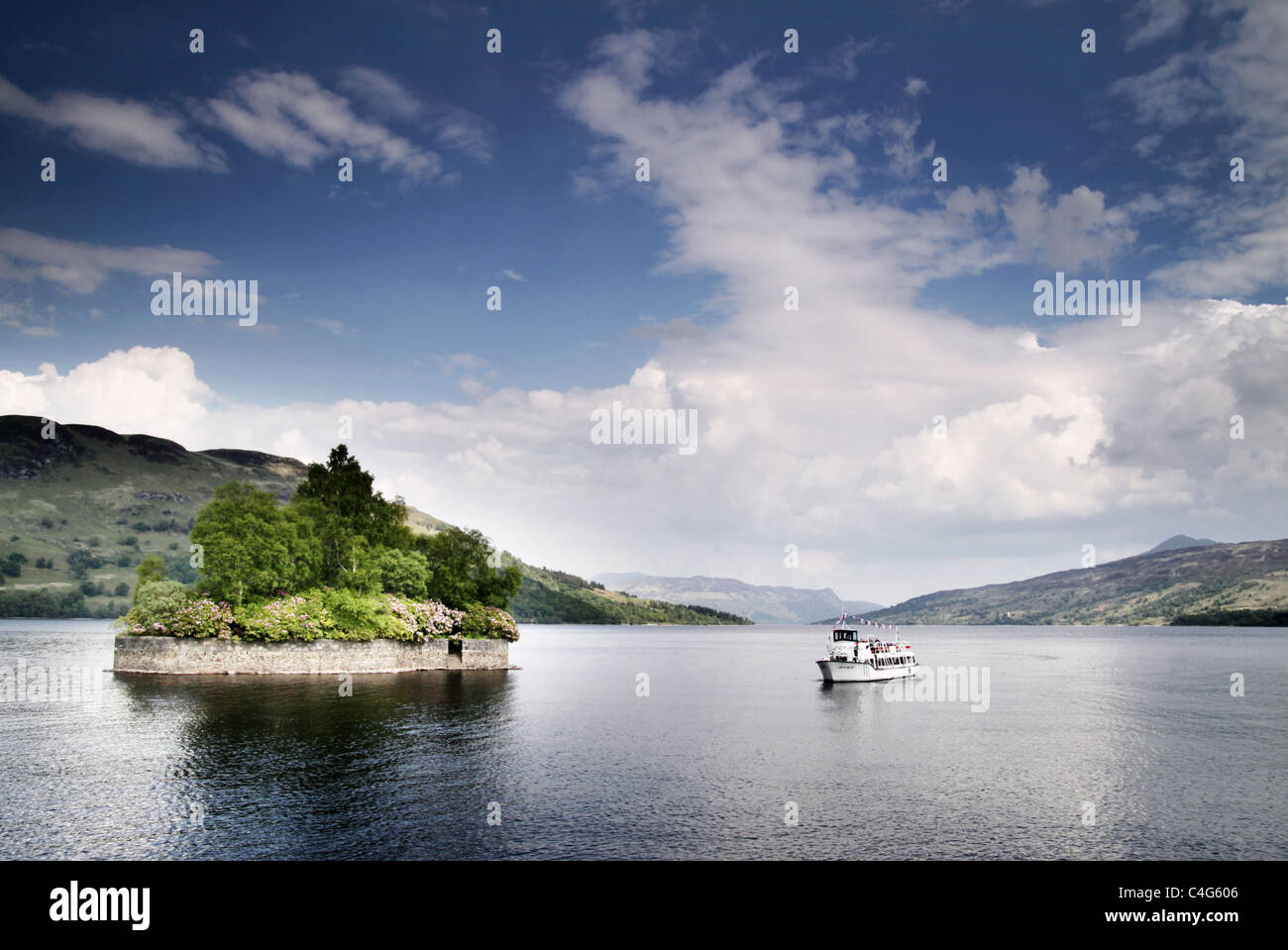boat sailing on a loch in Scotland Stock Photo