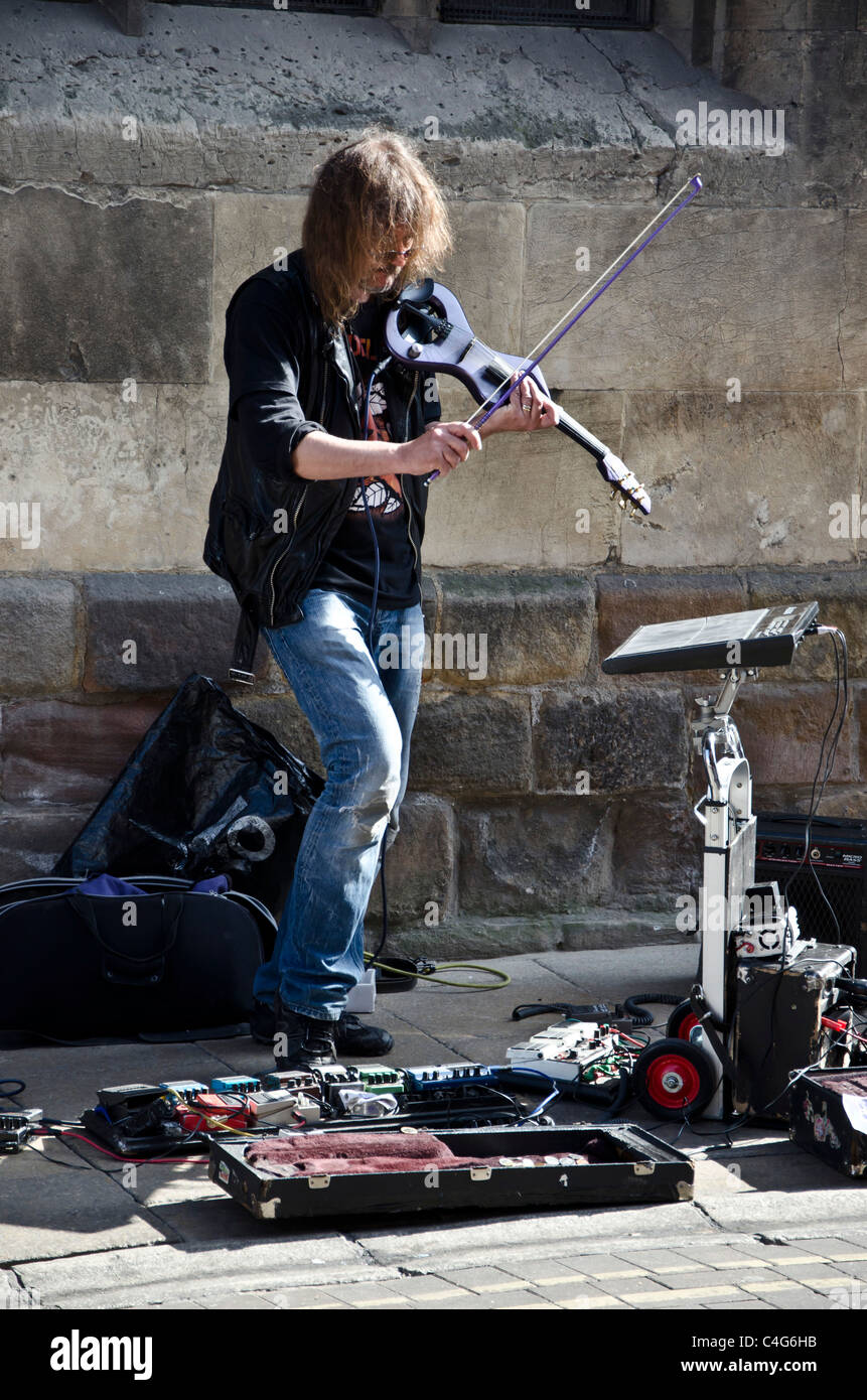 Electricviolinplaying busker in York City Centre, England Stock Photo