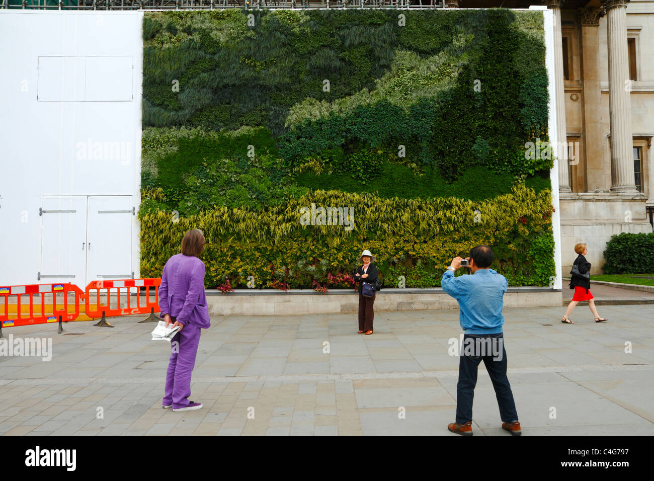 Passersby view 'A Living Painting' (Van Gogh's A Wheatfield with Cypresses) outside The National Gallery, London UK. Stock Photo