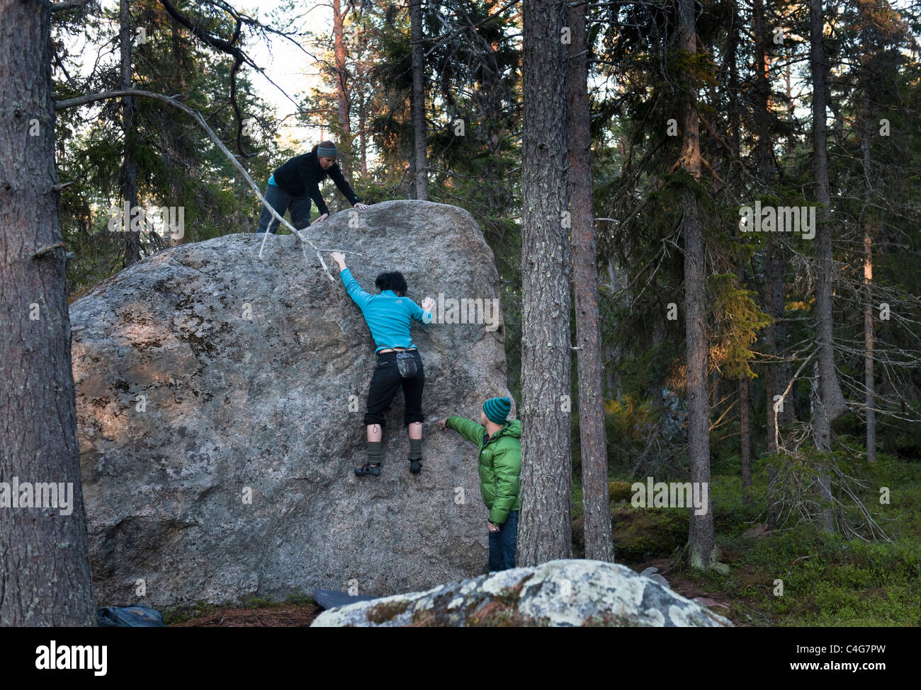 A Female Rock Climber Bouldering And Being Spotted By A Man Near Luleå 