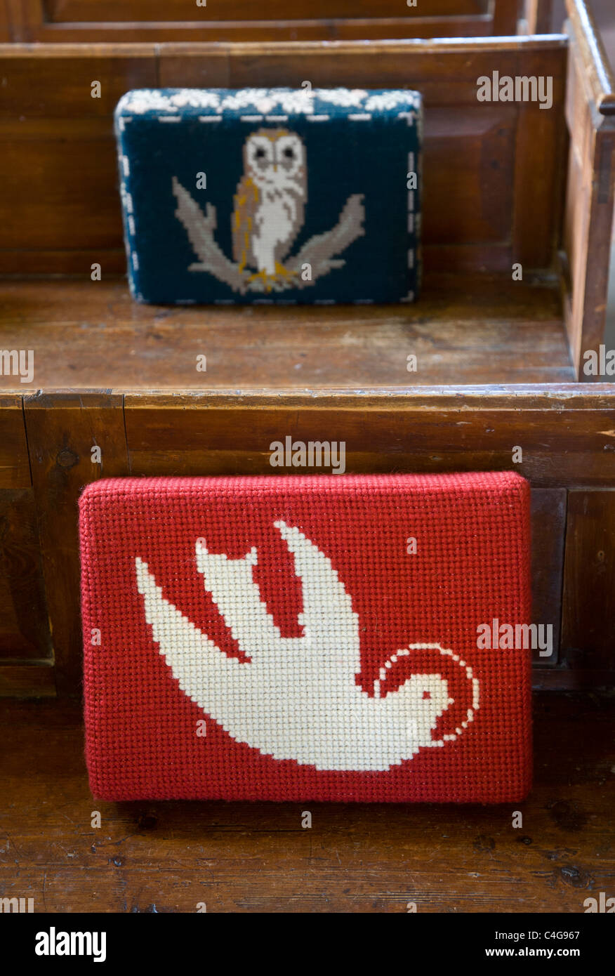 Hand stitched prayer cushions on pews at St Andres church, Little