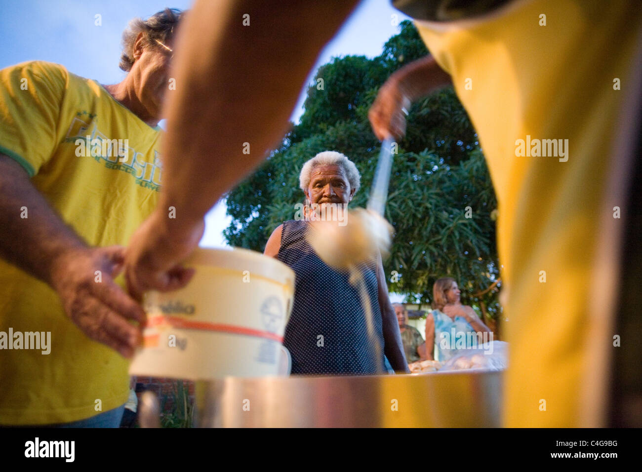 Distribution of soap and bread to poor people Making a better world, making a difference against poverty Stock Photo