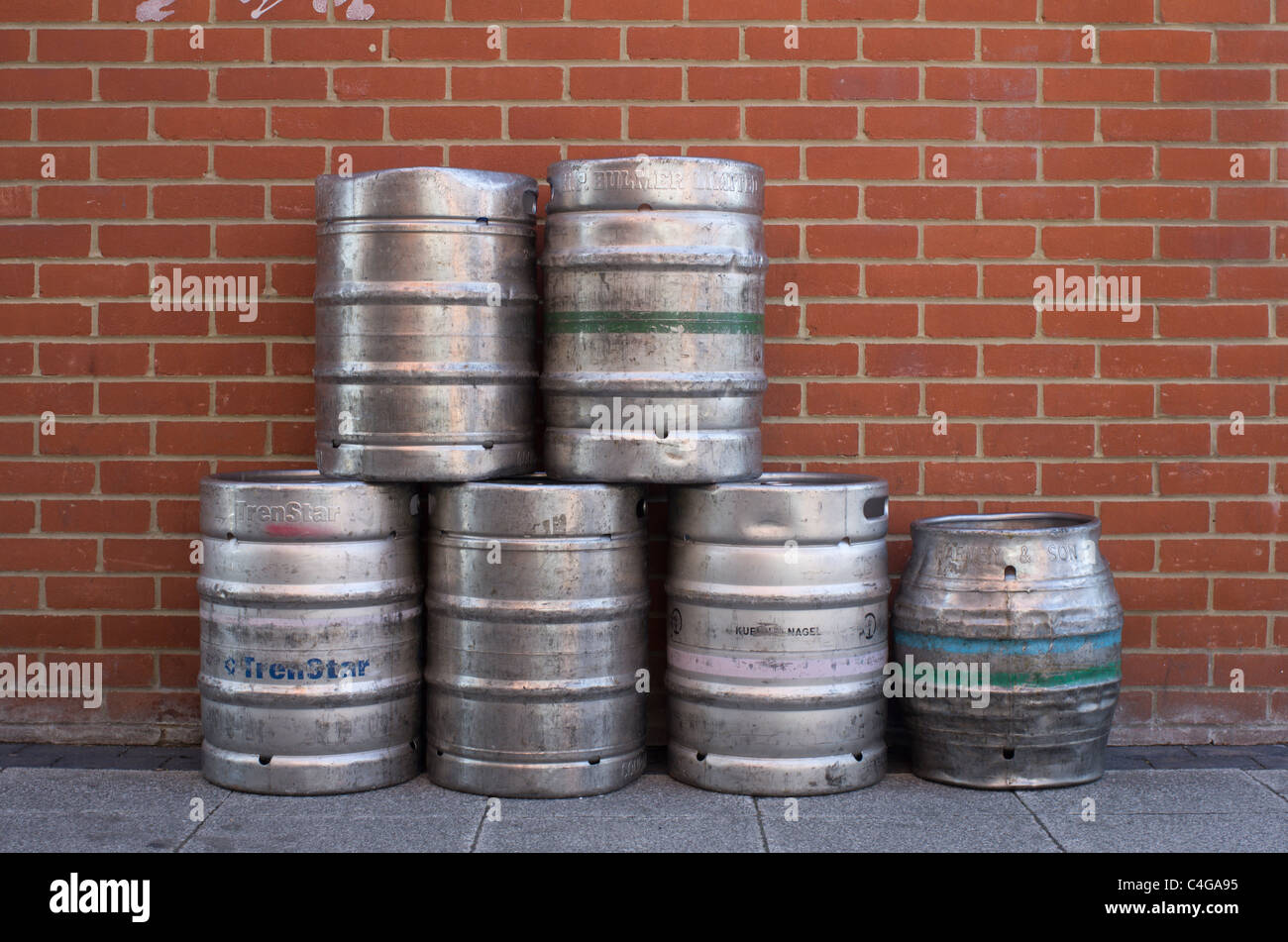 metal beer barrels stacked against a wall Stock Photo Alamy