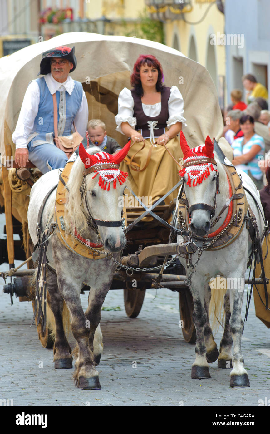 performer of the annual medieval parade Meistertrunk, dressed in historical costume in carriage and horse in Rothenburg, Germany Stock Photo