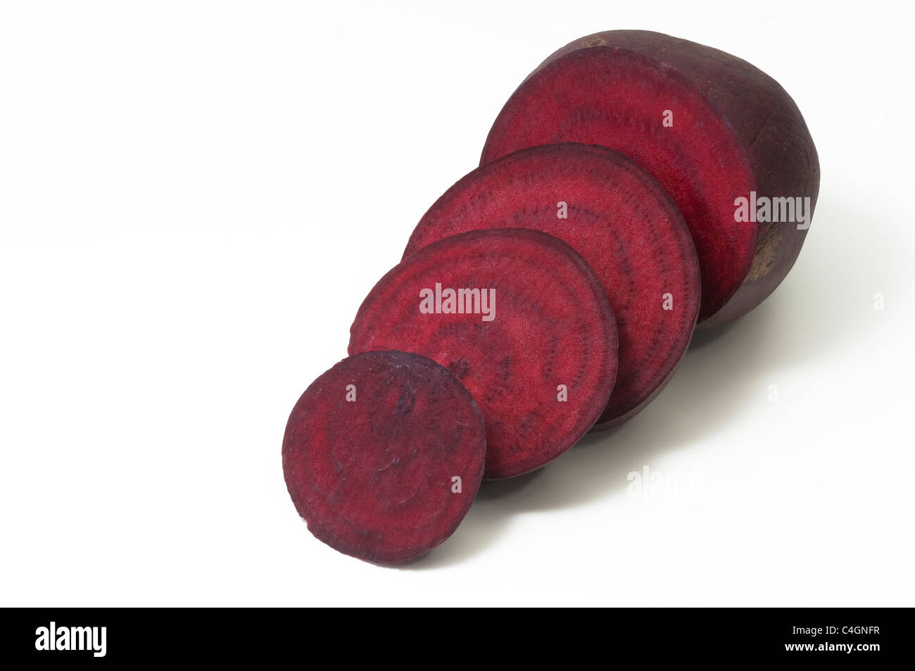 Red Beetroot, Root Beet (Beta vulgaris subsp. vulgaris var. conditiva). Sliced root, studio picture against a white background. Stock Photo