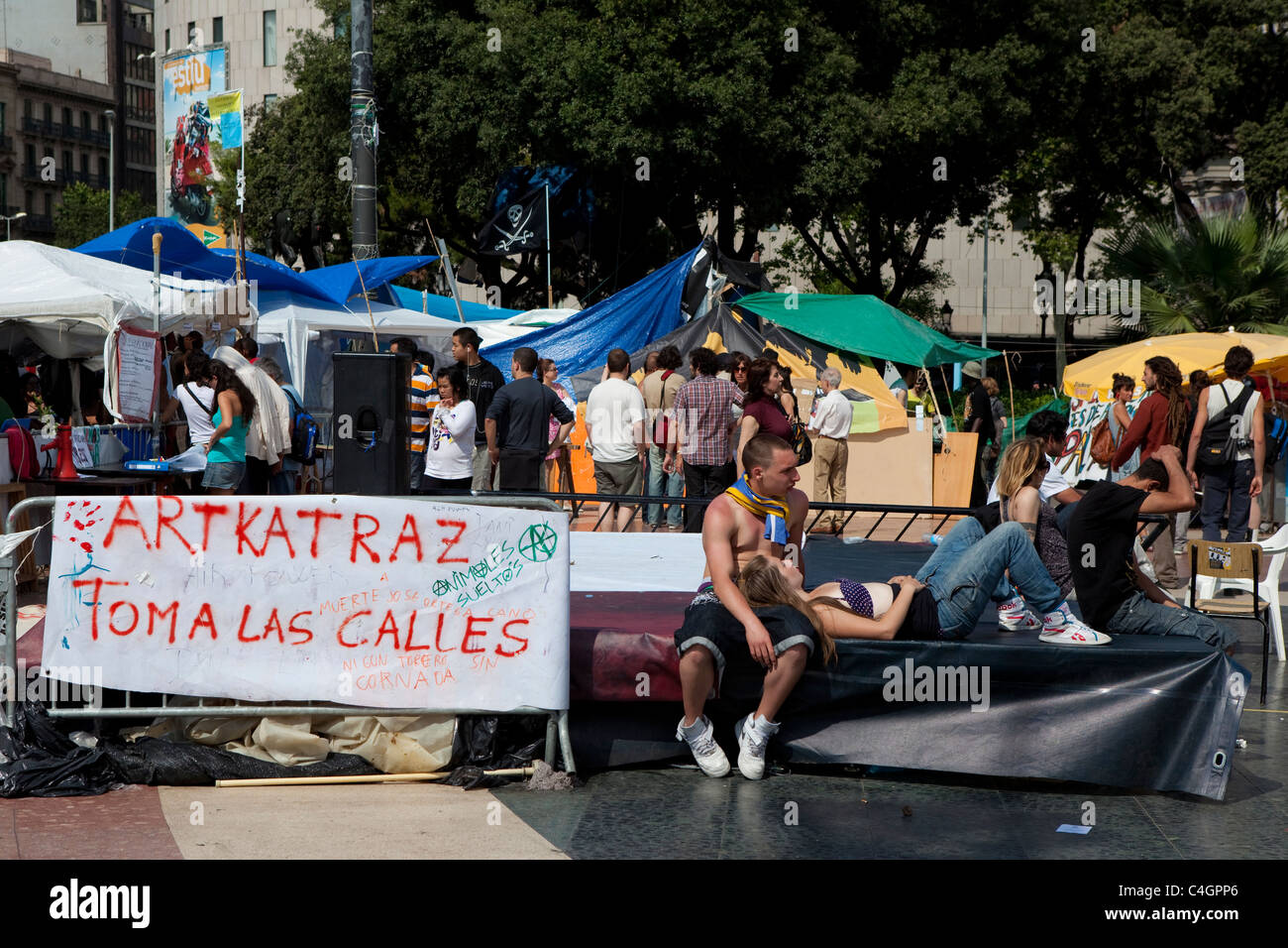 People enjoying afternoon sun at the antigovernment protest camp at Placa de Catalunya, Barcelona, Spain Stock Photo