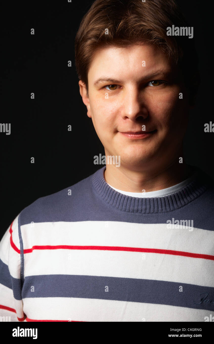 Close-up of a young man smiling and looking at camera Stock Photo - Alamy