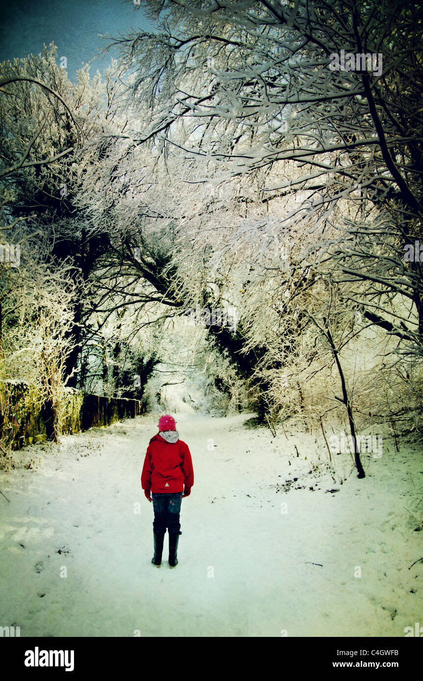 girl in red jacket in the snow Stock Photo