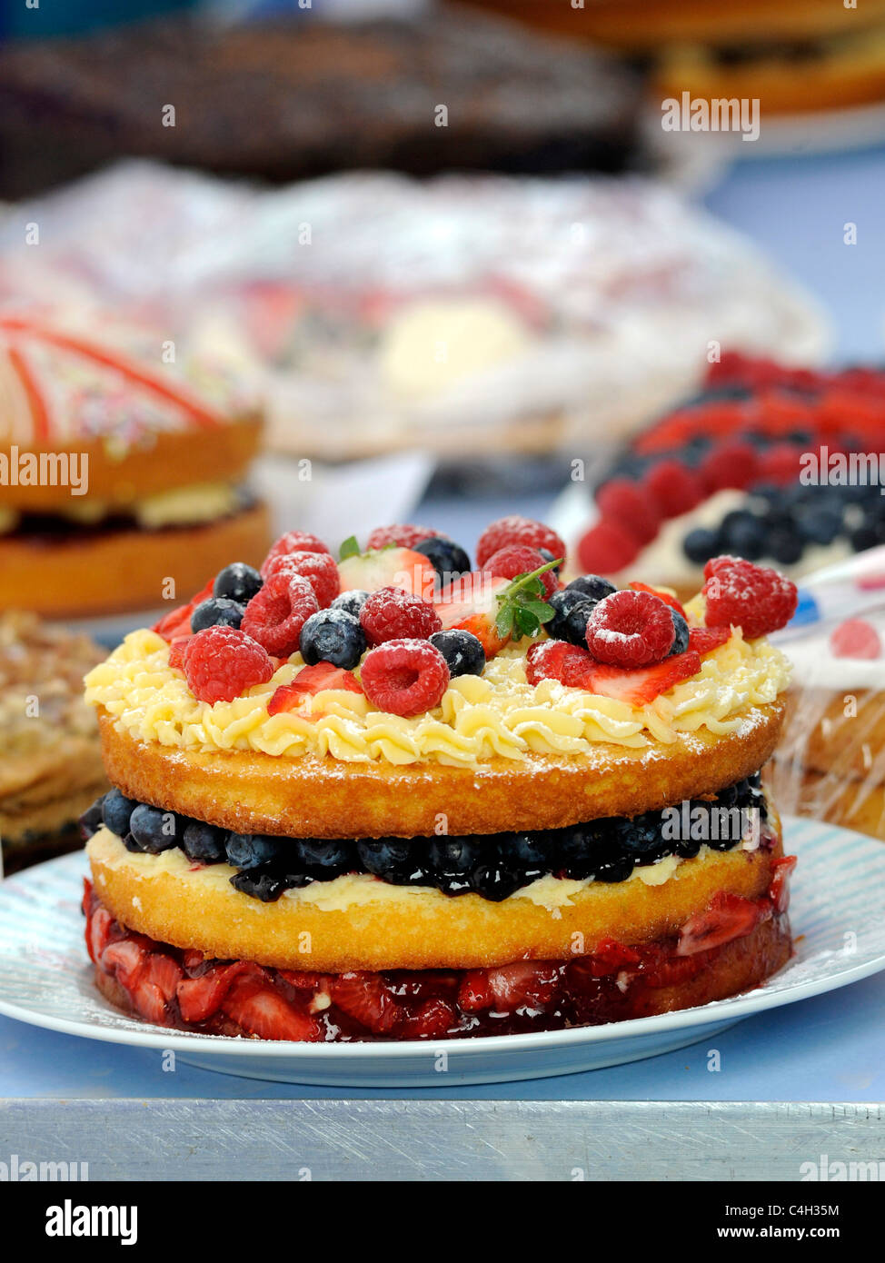 A large fruit cake at an old fashioned tea party. Stock Photo