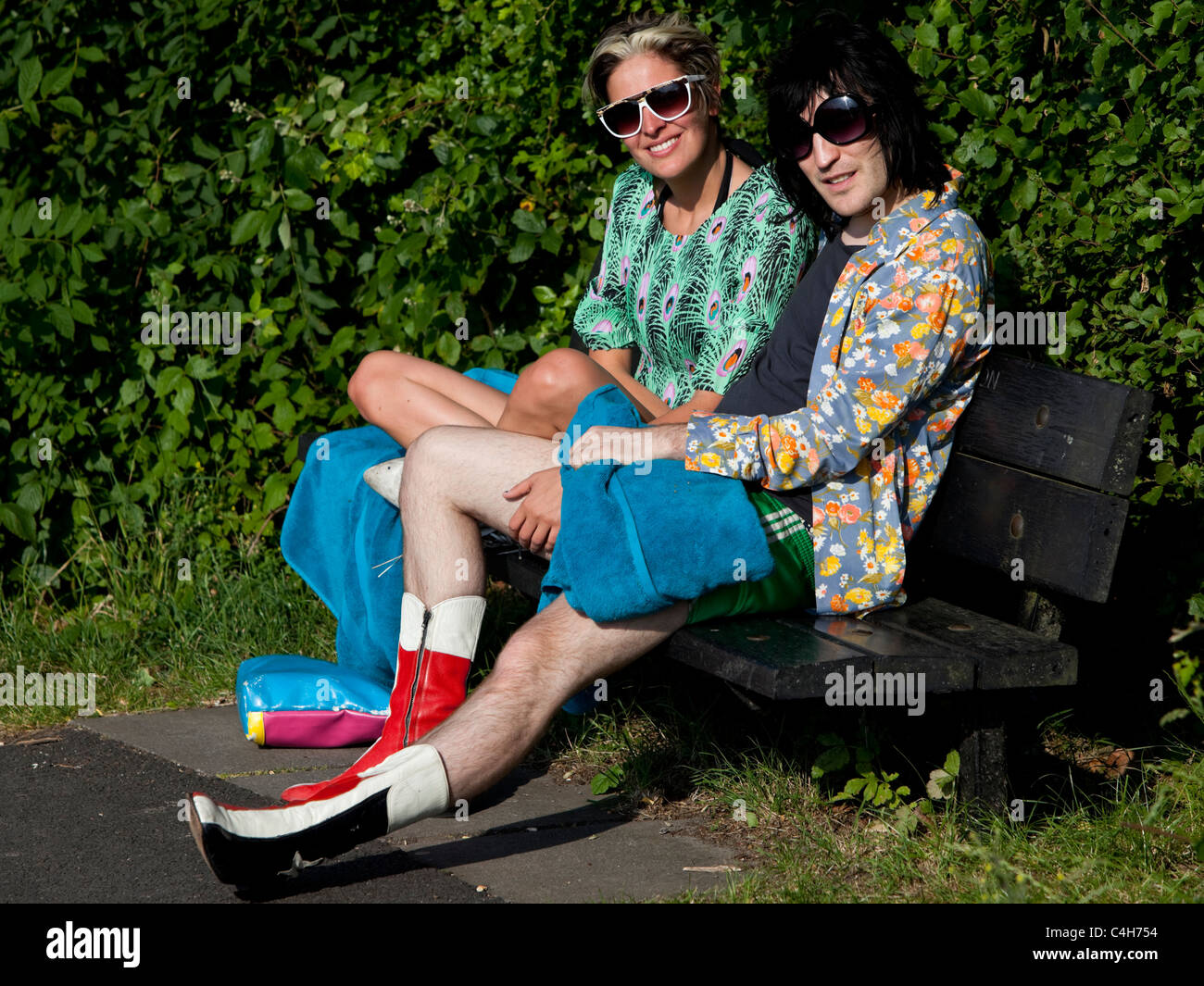 Noel Fielding sitting on a bench with a beautiful woman, Parliament Hill, Hampstead Heath, London, England, UK. Stock Photo