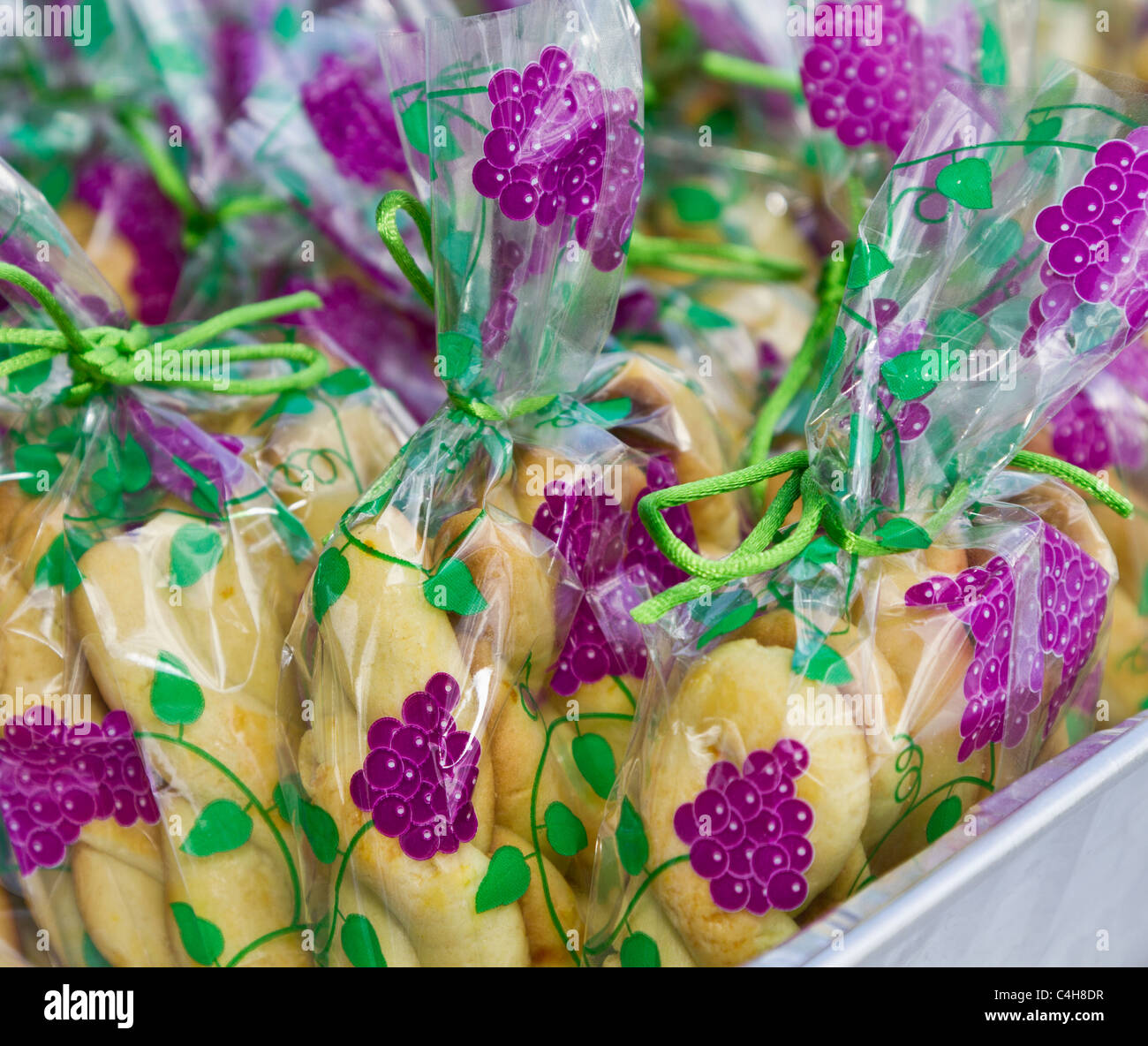 Koulourakia, traditional butter cookie of Greece, is gaily wrapped and tied for sale at a Greek Festival in NJ. Horizontal close up of ethnic food. Stock Photo
