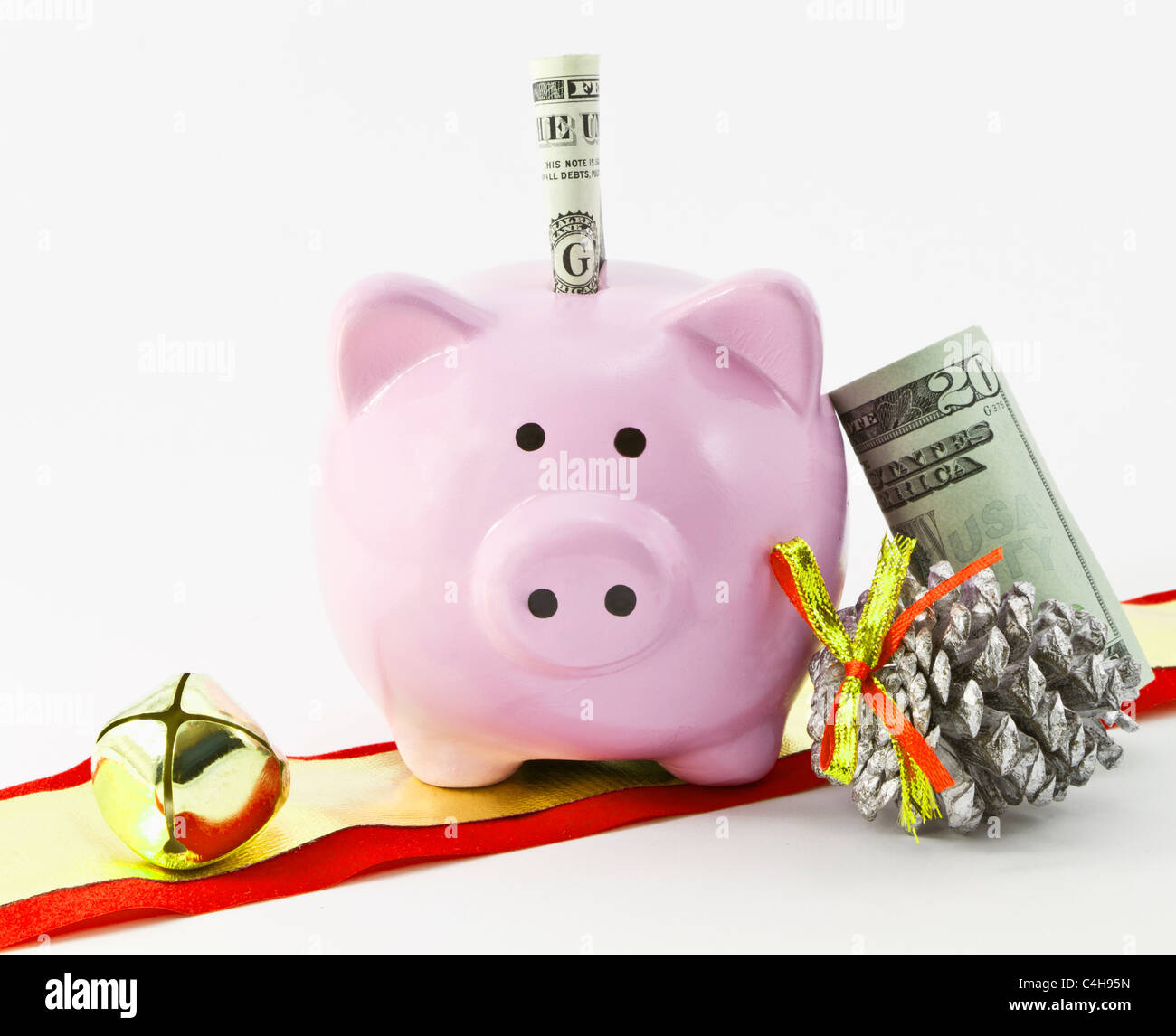 Pink bank holds currency and is placed with holiday items Stock Photo