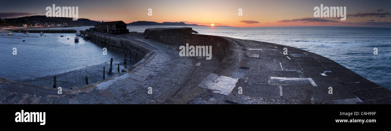 the Cobb at Lyme Regis at dawn with the Jurassic Coast beyond, Dorset, England, UK Stock Photo