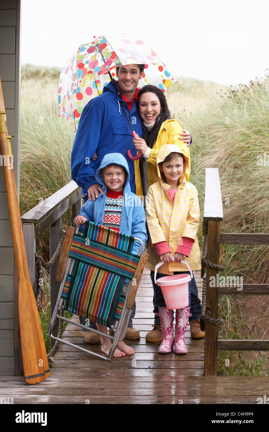 Family on beach with umbrella Stock Photo Alamy