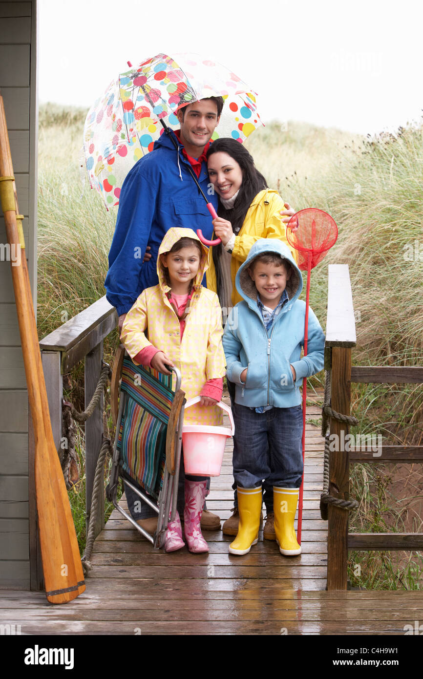 Family on beach with umbrella Stock Photo Alamy