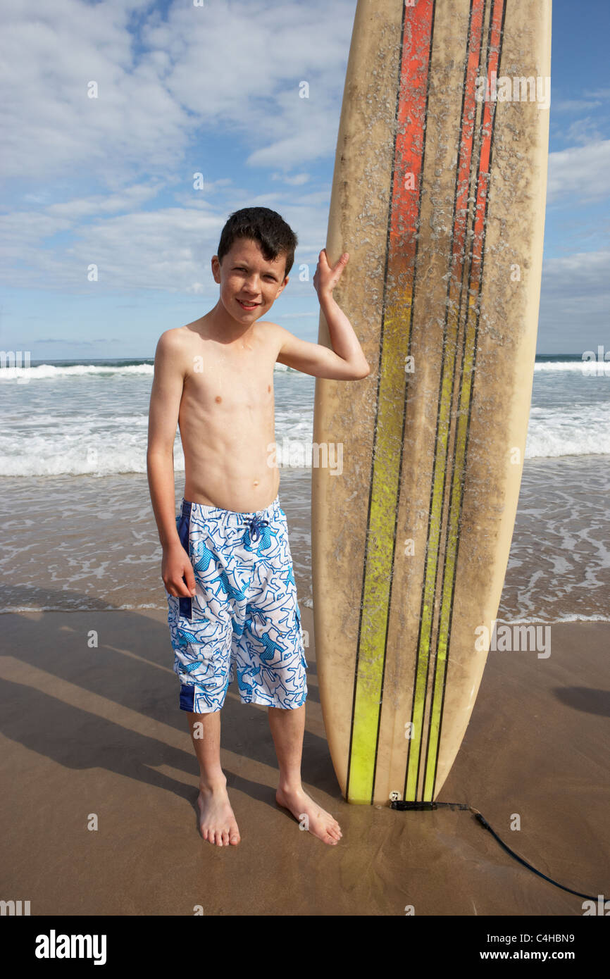 Teenage boy with surfboard Stock Photo