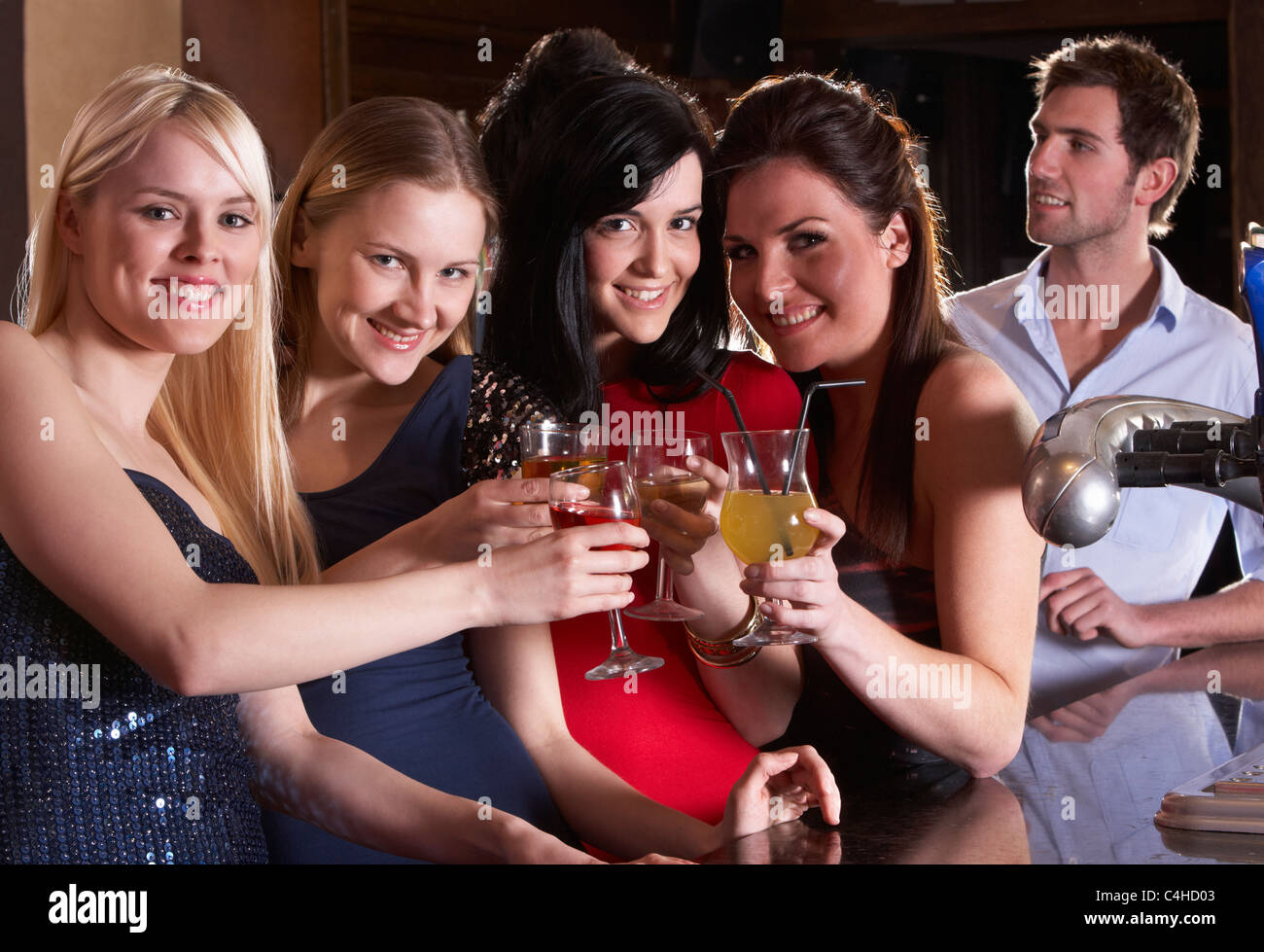 Young women drinking at bar Stock Photo