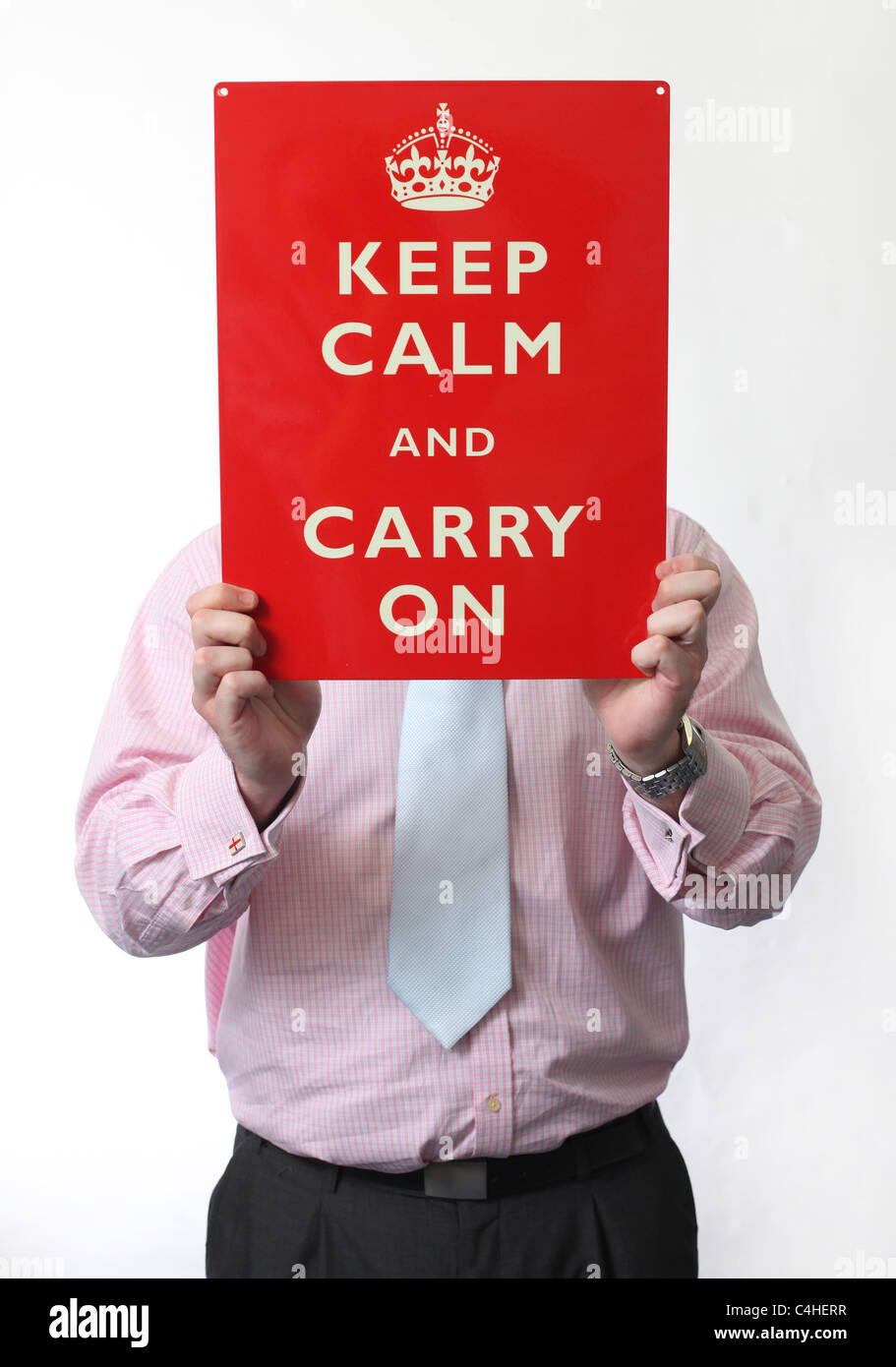Man holding a Keep Calm And Carry On sign. Picture by James Boardman. Stock Photo