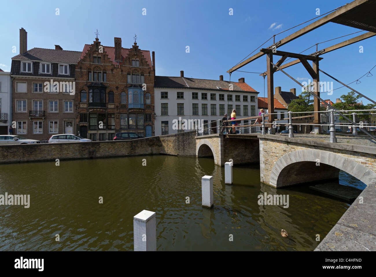 Lift bridge over the Lange Rei Canal in Bruges. The manually operated wooden bridge is an unusual sight on the Bruges canals. Stock Photo