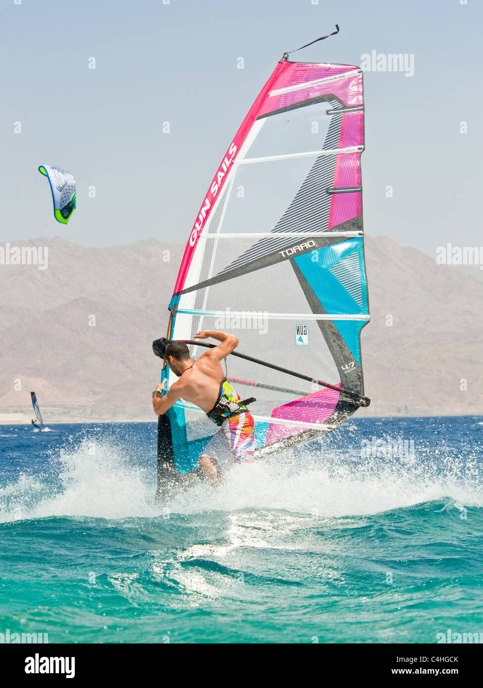 A windsurfer performing tricks on the red sea at the resort of Eilat in Israel. Stock Photo