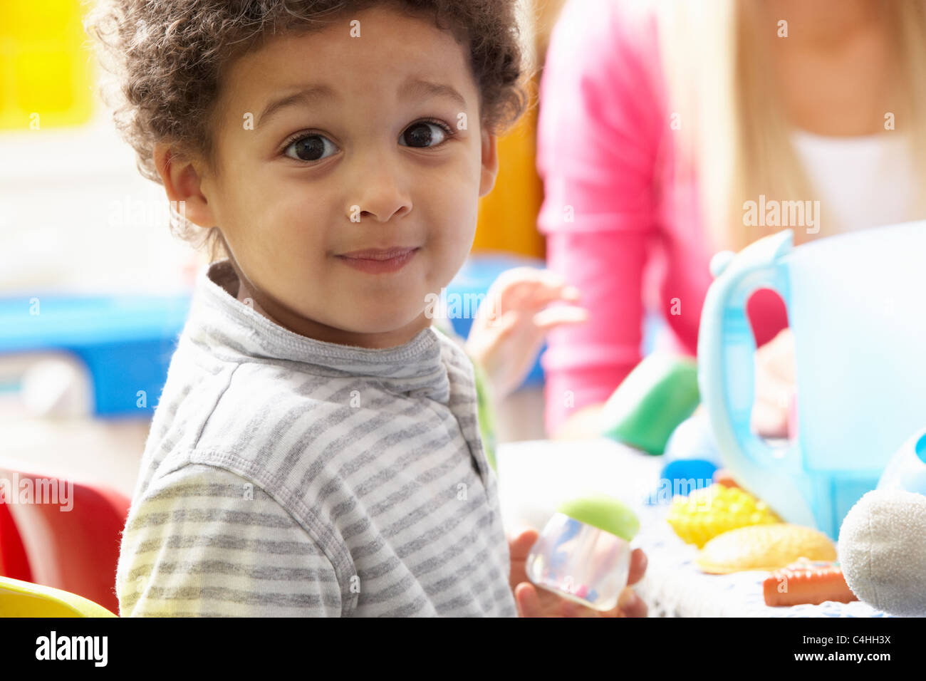 Boy playing with toys in nursery Stock Photo