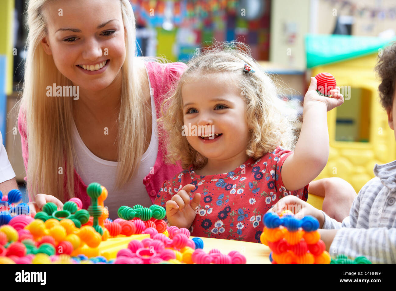 Young woman playing with girl Stock Photo