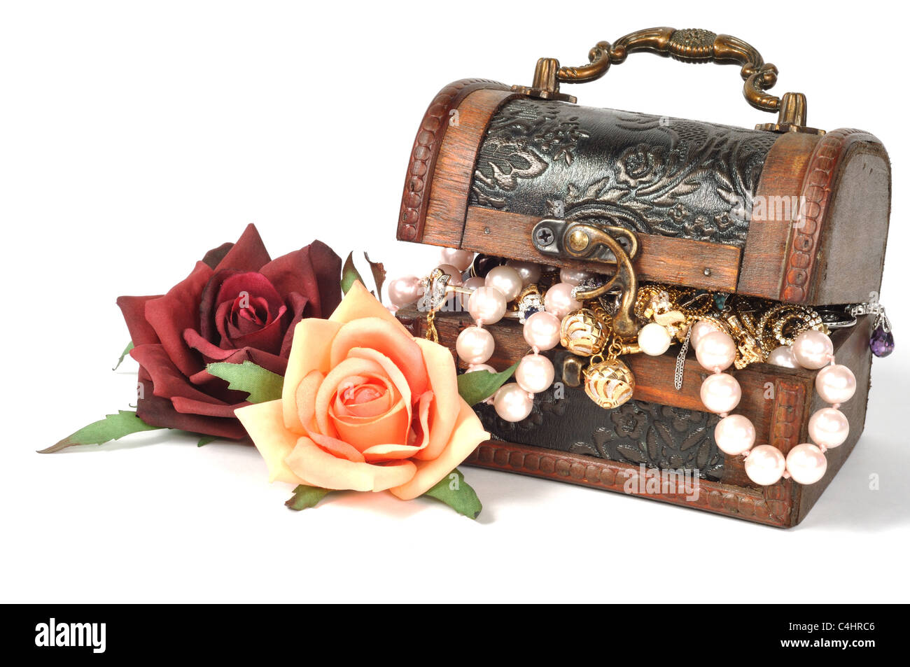 Wooden chest full of gold jewelry, with roses Stock Photo