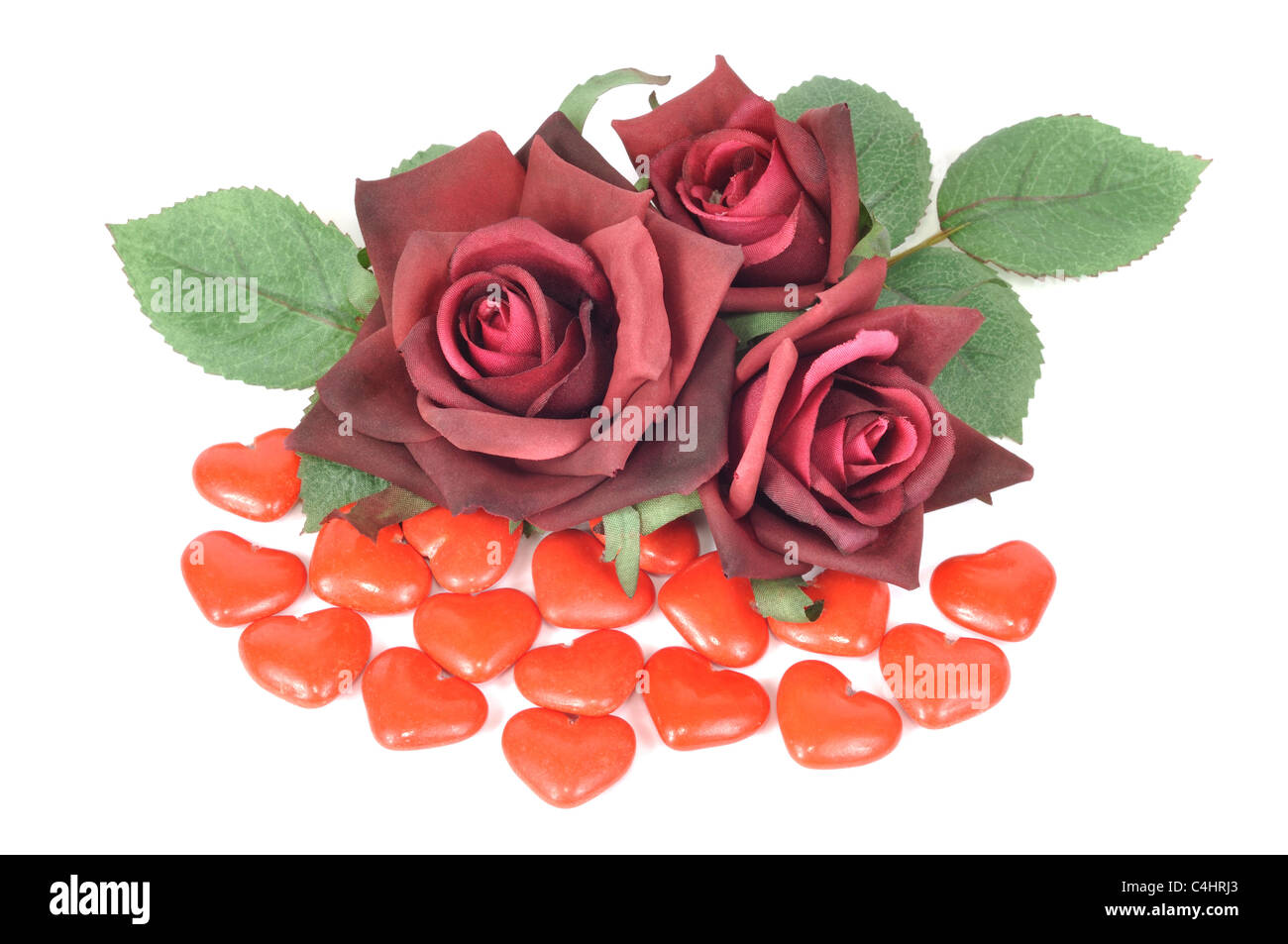 Chocolate candy in heart symbol and red roses Stock Photo - Alamy
