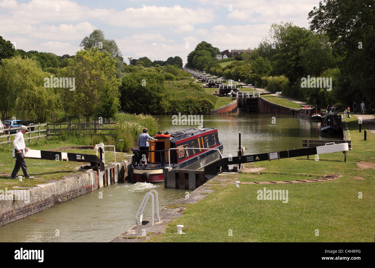 Canal boat going through one of the lock gates at Caen Hill locks, Kennet and Avon canal, Wiltshire, England, UK Stock Photo