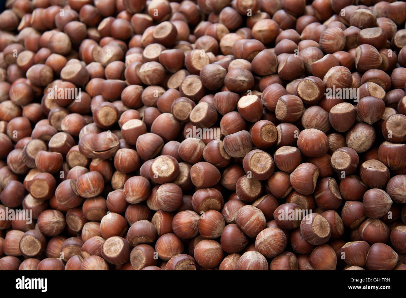 A close up to hazelnuts on a counter in an open marketplace Stock Photo