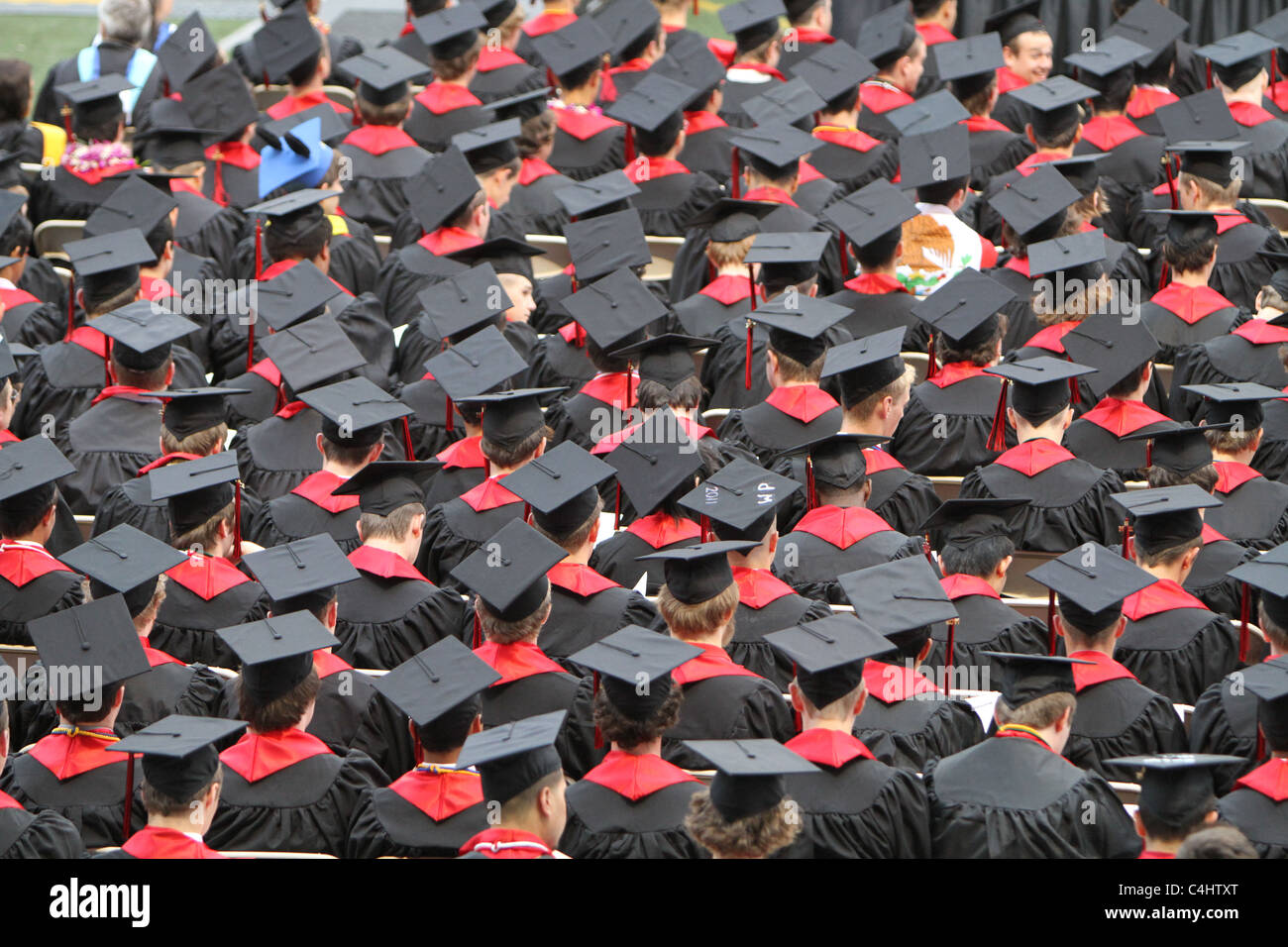 high-school graduation ceremony. Boys in black; Girls in Red Stock Photo