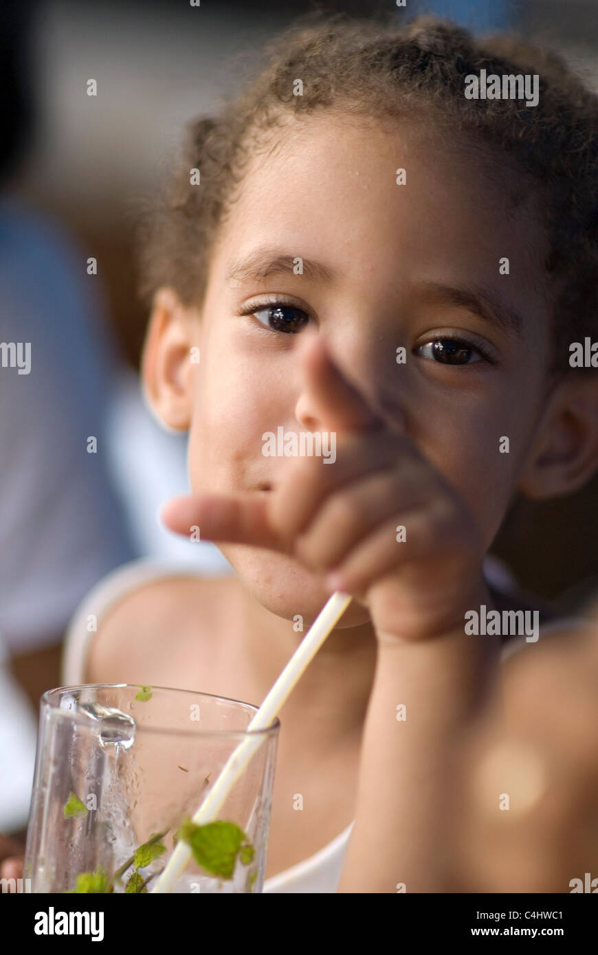 Young girl drinks a non-alcoholic Mojito at a cafe in Havana, Cuba. © Craig M. EiseAnberg Stock Photo