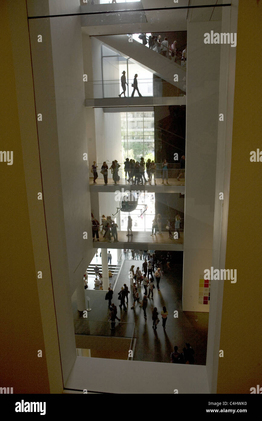 Visitors at The Museum Of Modern Art (MOMA) can be seen on all floors simultaneously with the open interior architecture. NYC Stock Photo