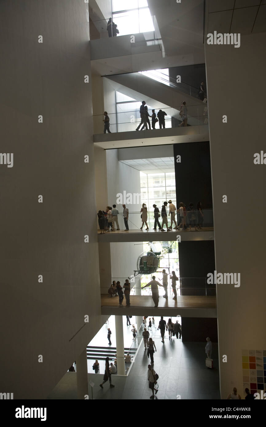 Visitors at The Museum Of Modern Art (MOMA) can be seen on all floors simultaneously with the open interior architecture. NYC Stock Photo