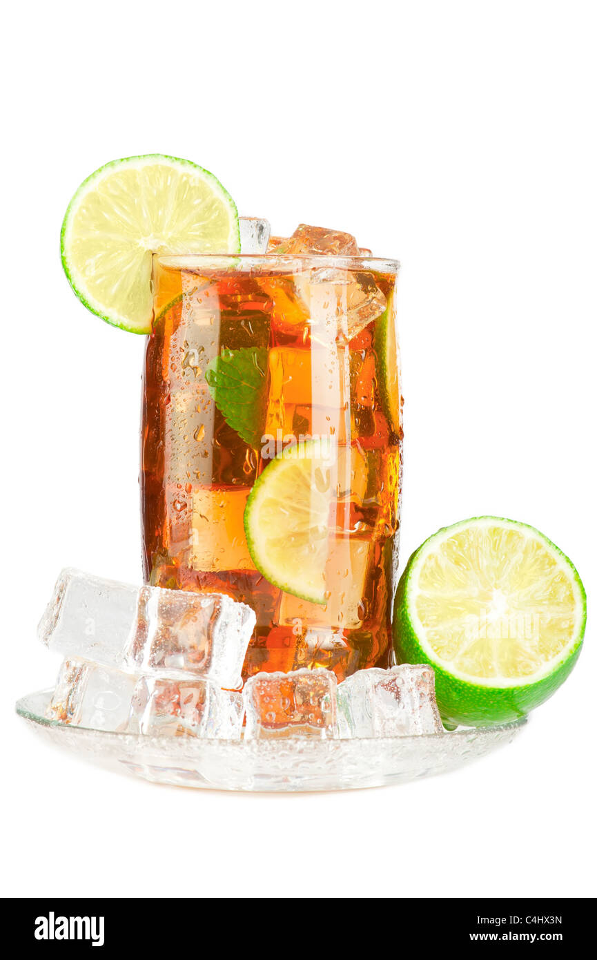 Glass of iced tea with ice cubes, lime and mint, covered with water
