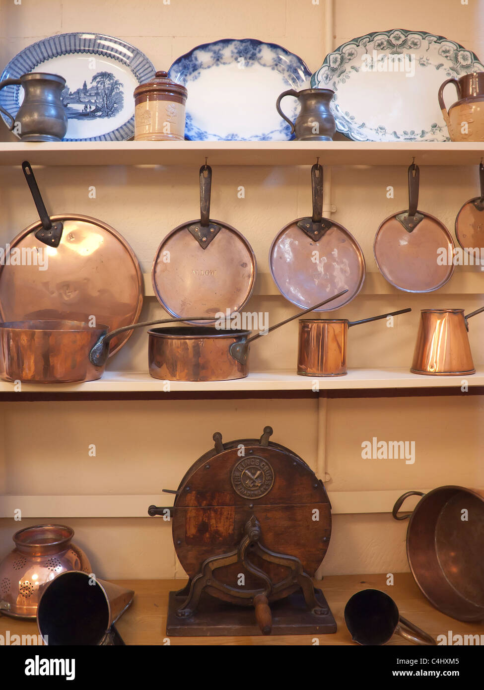 Old fashioned copper saucepans and ashets on display at Belsay Hall