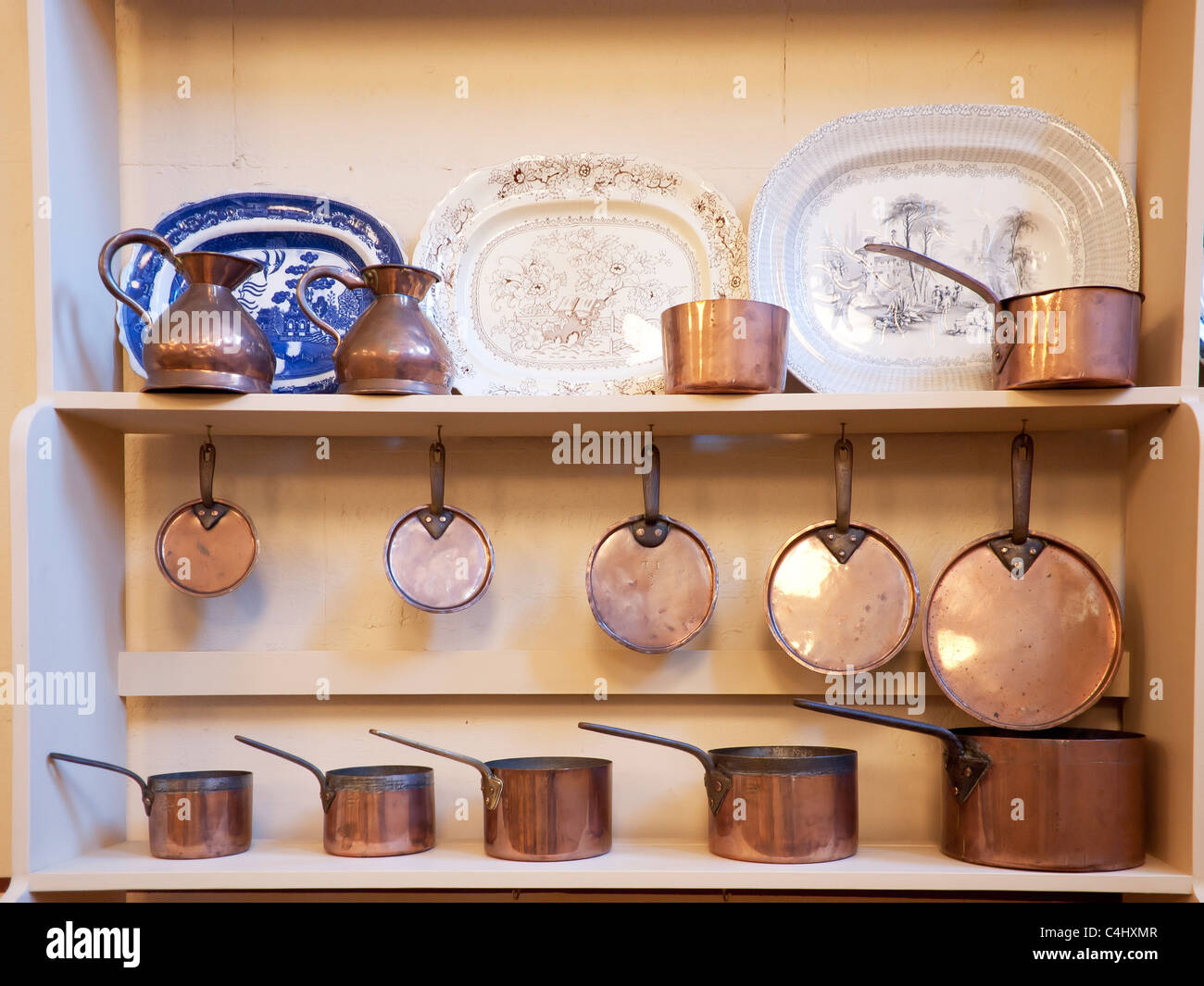 Old fashioned copper saucepans and ashets on display at Belsay Hall
