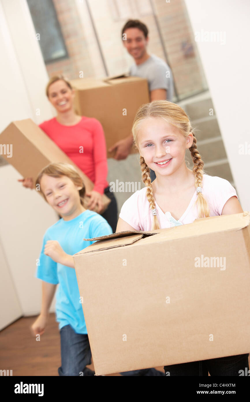 Family happy on moving day carrying cardboard boxes Stock Photo