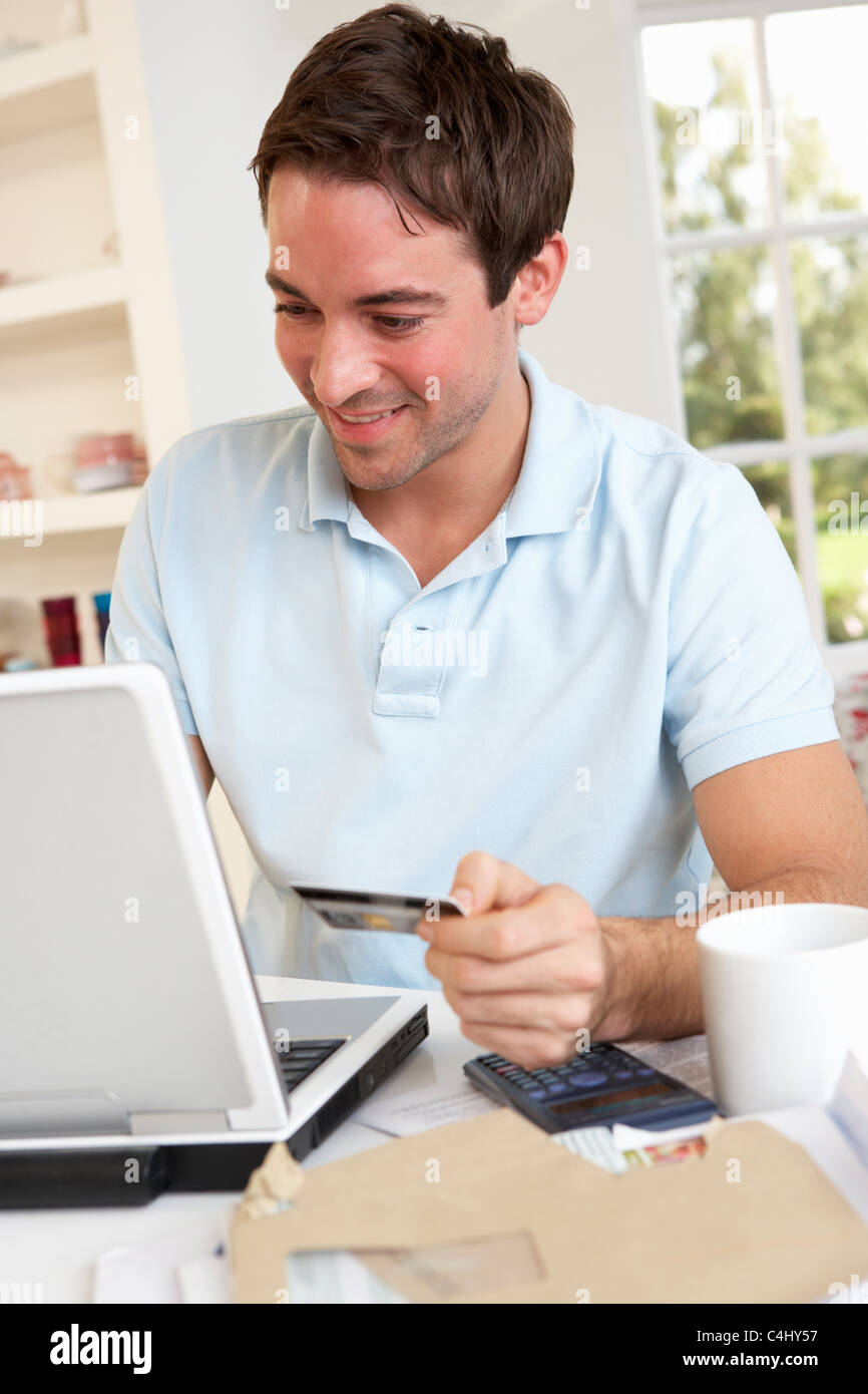 Young man using credit card on the internet Stock Photo