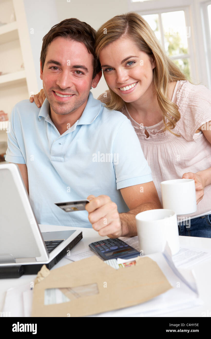 Young couple using credit card on the internet Stock Photo